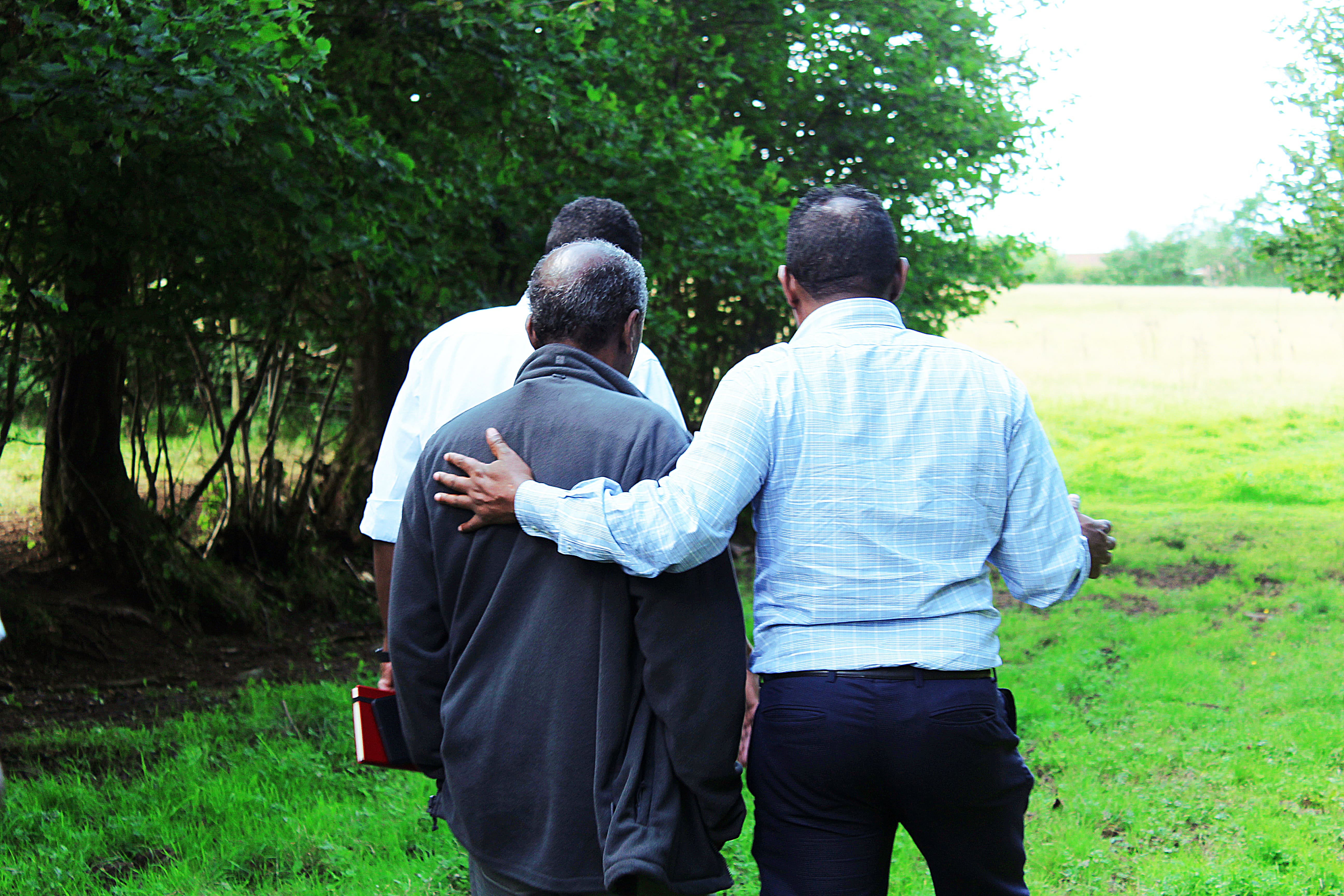 Refugee with arm around another refugee