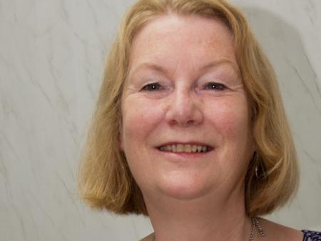 Headshot of Eileen who helps ACH help female refugees and women migrants