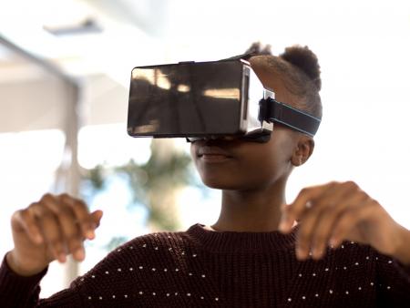 UKBlackTech image of young black girl using virtual reality technology