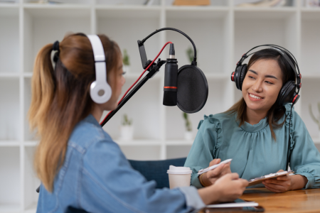 Podcast blog picture, two women recording a podcast at the office