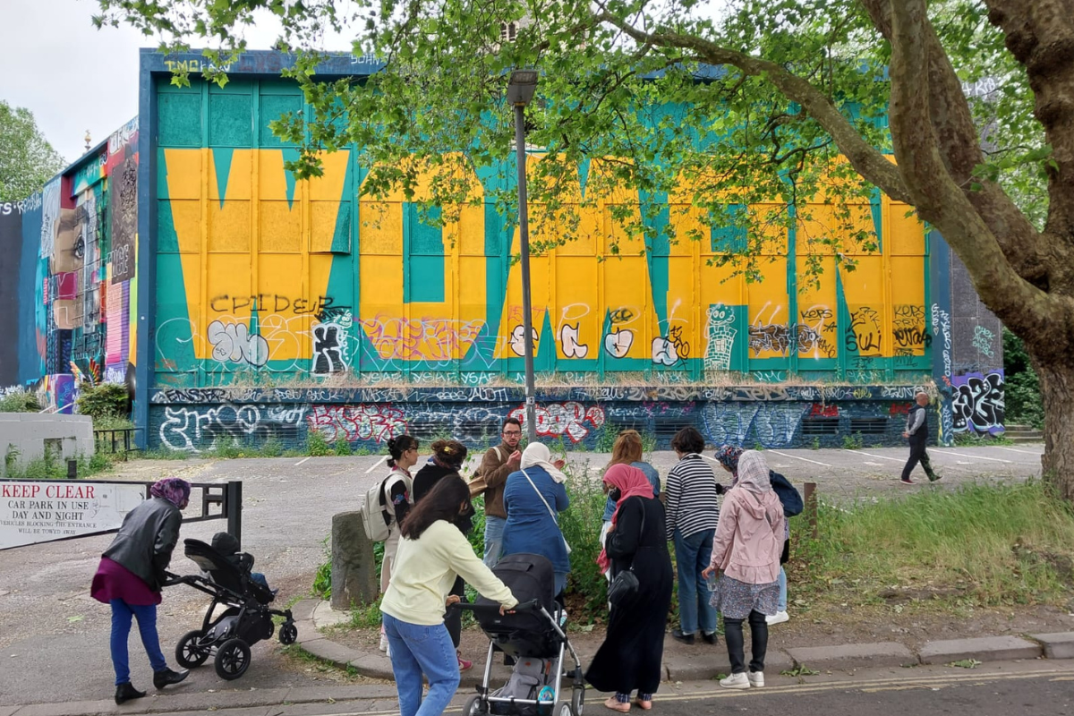 Attendees in front of the woman wall