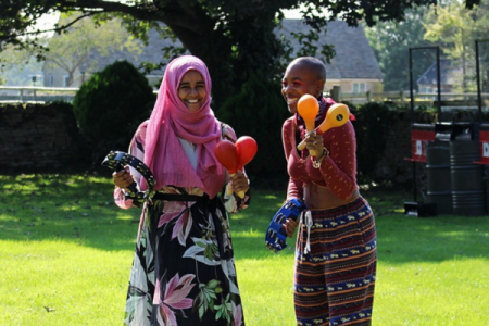 Two ACH staff members playing instruments at staff away day